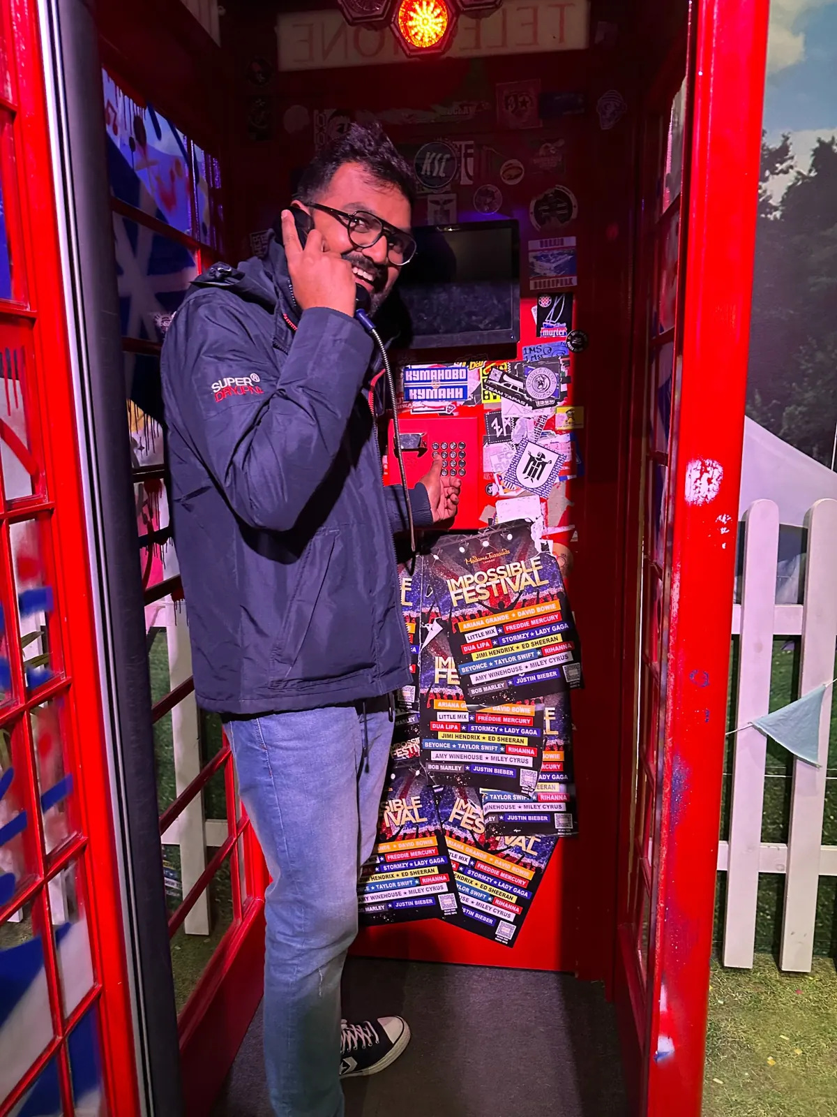 Inside a bright red telephone booth