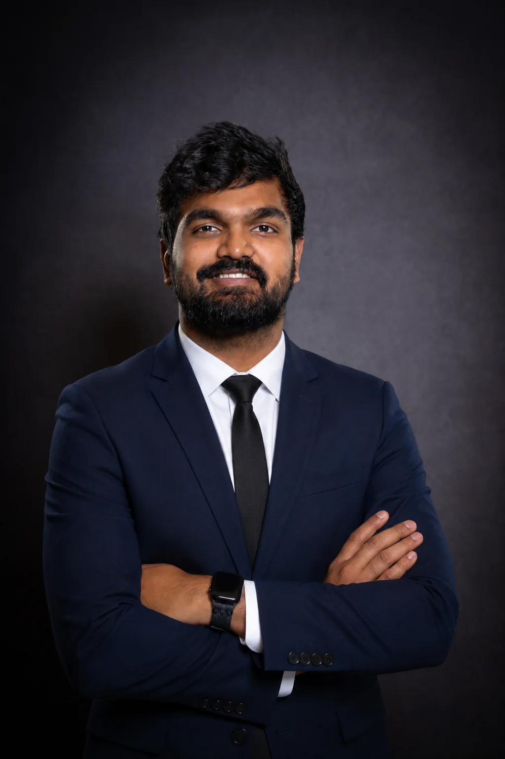 Professional portrait of Naga wearing a navy suit